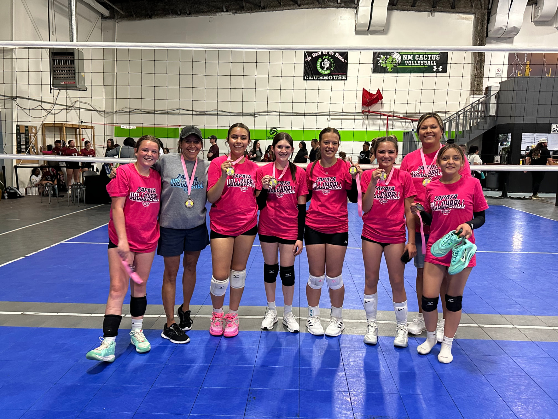 Zapata VBC team in pink shirts with medals